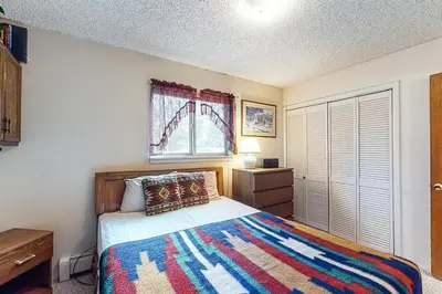 a bedroom with a bed and a window at Hi Country Haus 11-2 in Winter Park