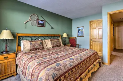 a bedroom with a large bed and green walls at 11 Mi to Keystone Silverthorne Condo with Deck in Silverthorne