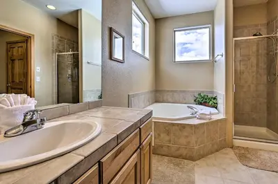 a bathroom with a tub and a sink at 11 Mi to Keystone Silverthorne Condo with Deck in Silverthorne