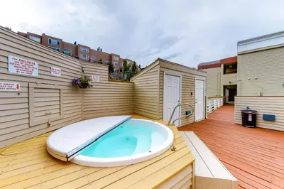 a hot tub sitting on top of a deck at Watch Hill Lofted in Silverthorne