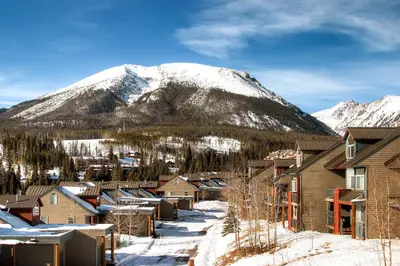 a town in front of a snow covered mountain at Watch Hill Lofted in Silverthorne