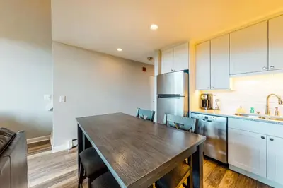 a kitchen with a large wooden table and chairs at Watch Hill Lofted in Silverthorne