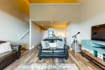 a living room with a couch and a television at Watch Hill Lofted in Silverthorne