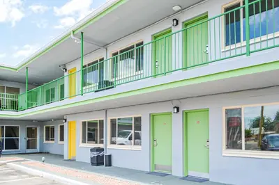 a building with green and yellow doors and windows at GREELEY UNIVERSITY INN/ GREELEY INN in Greeley
