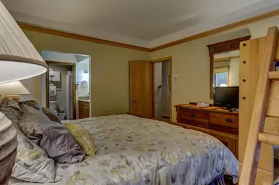 a bedroom with a bed and a television in it at Chateaux DuMont 2716 in Keystone