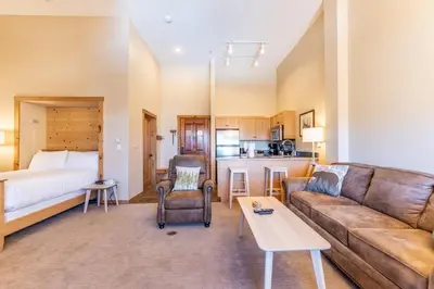 a living room with a couch and a bed at Buffalo Lodge by Summit County Mountain Retreats in Keystone