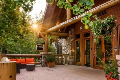 a building with a couch on a patio at Arapahoe Lodge by Summit County Mountain Retreats in Keystone