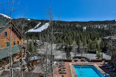 a view of a resort with a pool and a mountain at Dakota Lodge by Summit County Mountain Retreats in Keystone