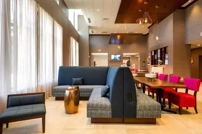 a living room with a blue couch and a table at Hampton Inn & Suites Aurora South, Co in Aurora