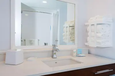 a white bathroom with a sink and a mirror at Hampton Inn & Suites Aurora South, Co in Aurora