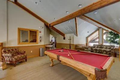 a living room with a pool table in it at Hidden River Lodge by Summit County Mountain Retreats in Keystone