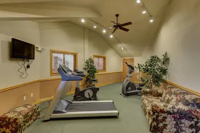 a living room with a couch and exercise equipment at Hidden River Lodge by Summit County Mountain Retreats in Keystone