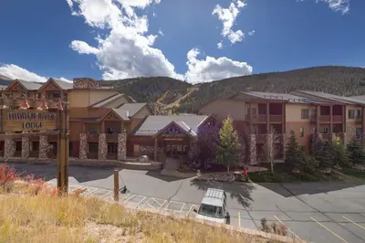 a large lodge with a parking lot in front of it at Hidden River Lodge by Summit County Mountain Retreats in Keystone