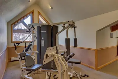 a gym with two treadmills and two exercise bikes at Hidden River Lodge by Summit County Mountain Retreats in Keystone