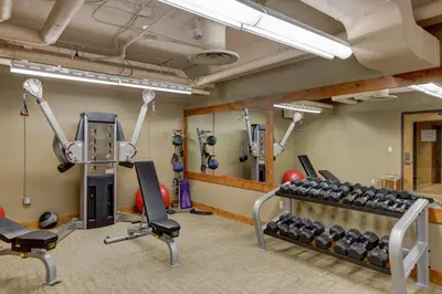 a fitness room with a gym with weights at Jackpine Lodge by Summit County Mountain Retreats in Keystone