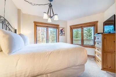 a bedroom with a large bed and a television at Red Hawk Lodge by Summit County Mountain Retreats in Keystone