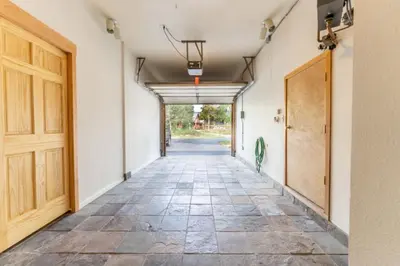 an empty hallway with a door and a tile floor at Snake River Village by Summit County Mountain Retreats in Keystone