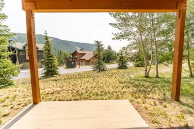 an open porch with a view of a yard at Snake River Village by Summit County Mountain Retreats in Keystone