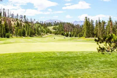 a view of a golf course with a green at Snake River Village by Summit County Mountain Retreats in Keystone