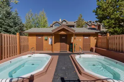 a house with two hot tubs in a backyard at Snake River Village by Summit County Mountain Retreats in Keystone