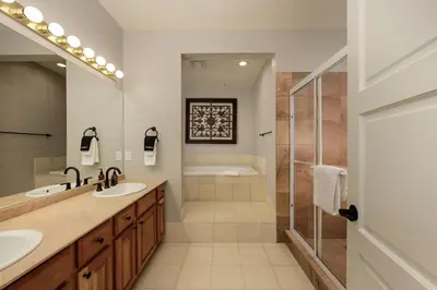 a bathroom with two sinks and a shower at Trademark Condo Short Walk to Shuttle in Winter Park