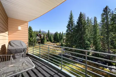 a balcony with a table and a view of the mountains at Trademark Condo Short Walk to Shuttle in Winter Park