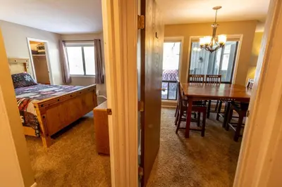 a bedroom and dining room with a bed and a table at Flying Dutchman by Summit County Mountain Retreats in Keystone