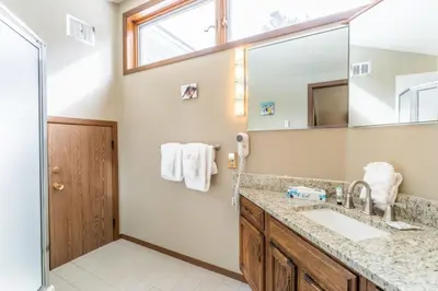 a bathroom with a sink and a mirror at Flying Dutchman by Summit County Mountain Retreats in Keystone