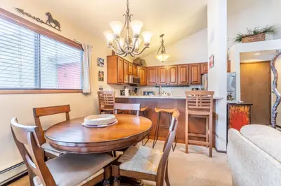 a kitchen and dining room with a table and chairs at Flying Dutchman by Summit County Mountain Retreats in Keystone