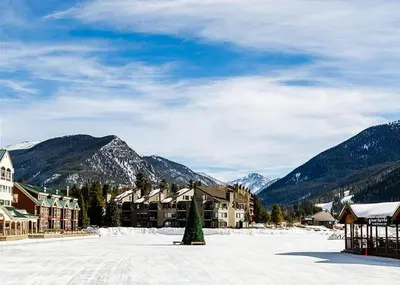 a snow covered town with mountains in the background at Alders by Summit County Mountain Retreats in Keystone
