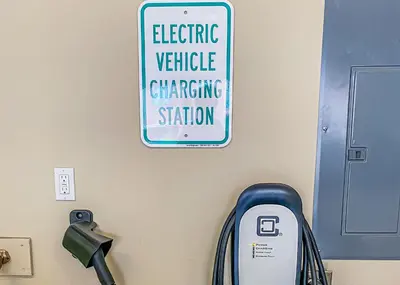 a sign on a wall with an electric vehicle charging station at Alders by Summit County Mountain Retreats in Keystone