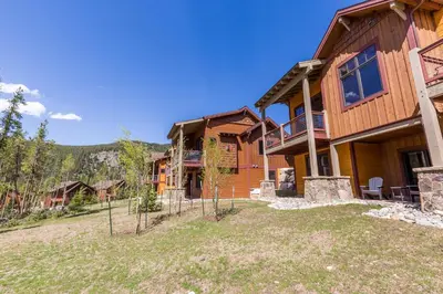a large house with a fence in front of it at Alders by Summit County Mountain Retreats in Keystone