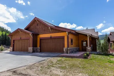 a house with two garage doors on a driveway at Alders by Summit County Mountain Retreats in Keystone