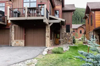 a house with a deck and a garage at Alders by Summit County Mountain Retreats in Keystone