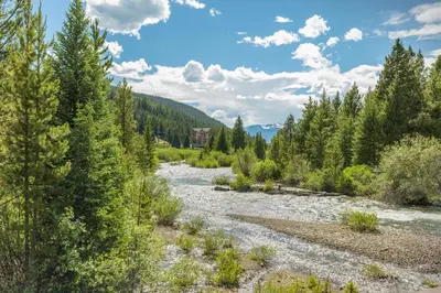 a river in the middle of a forest at Alders by Summit County Mountain Retreats in Keystone