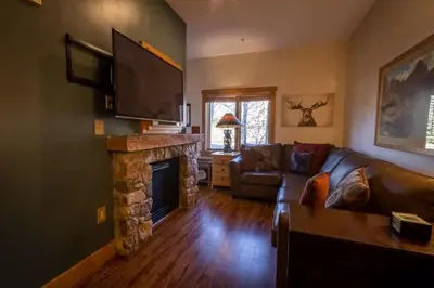 a living room with a couch and a fireplace at Expedition Station by Summit County Mountain Retreats in Keystone
