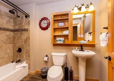 a bathroom with a toilet and a sink and a tub at Expedition Station by Summit County Mountain Retreats in Keystone