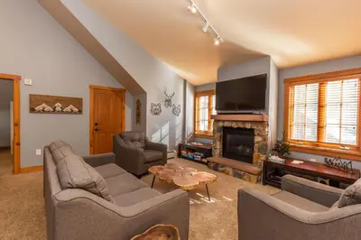 a living room with couches and a tv and a fireplace at Expedition Station by Summit County Mountain Retreats in Keystone