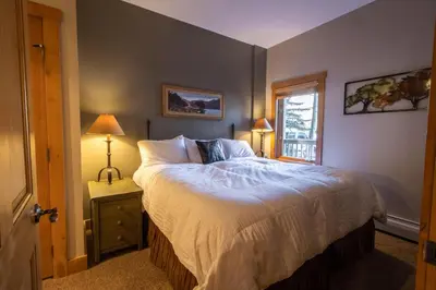 a bedroom with a large bed and a window at Expedition Station by Summit County Mountain Retreats in Keystone