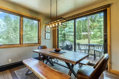 a dining room with a table and chairs and windows at Ironwood Townhome 2989 - Keystone2989com in Keystone