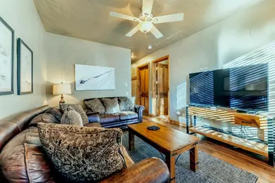 a living room with a leather couch and a tv at Ironwood Townhome 2989 - Keystone2989com in Keystone