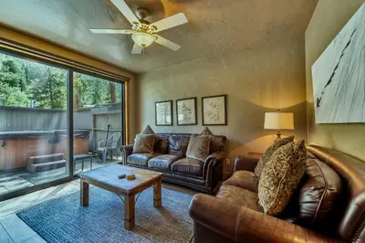 a living room with leather furniture and a ceiling fan at Ironwood Townhome 2989 - Keystone2989com in Keystone