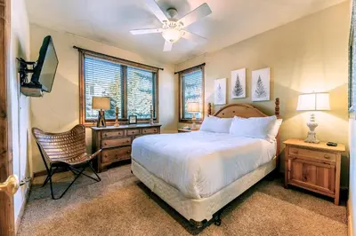 a bedroom with a bed and a desk and a television at Ironwood Townhome 2989 - Keystone2989com in Keystone