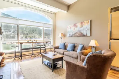 a living room with a couch and a table at Lakeshore by Summit County Mountain Retreats in Keystone