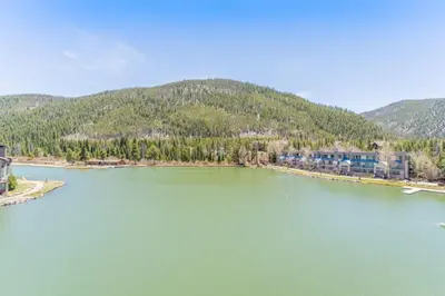 a view of a river with mountains in the background at Lakeshore by Summit County Mountain Retreats in Keystone