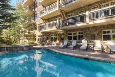 a swimming pool in front of a building at Lone Eagle by Summit County Mountain Retreats in Keystone