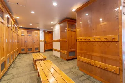 a locker room with wooden lockers and benches at Lone Eagle by Summit County Mountain Retreats in Keystone