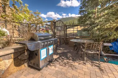 a grill sitting on a patio with a table at Lone Eagle by Summit County Mountain Retreats in Keystone