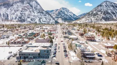 an aerial view of a town with mountains in the background at River Run Townhomes by Summit County Mountain Retreats in Keystone