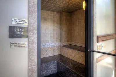 a bathroom with a shower stall with a sign on the door at Red Hawk Townhomes by Summit County Mountain Retreats in Keystone